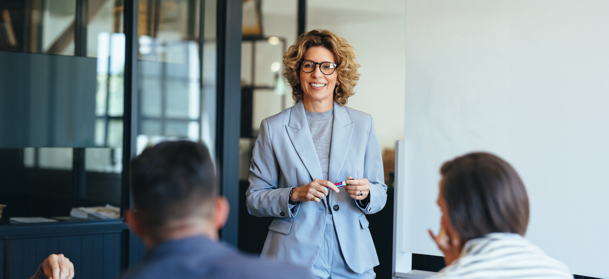 A Business Woman Leads A Meeting With Her Team In Office